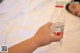 A person holding a bottle of water in their hand.